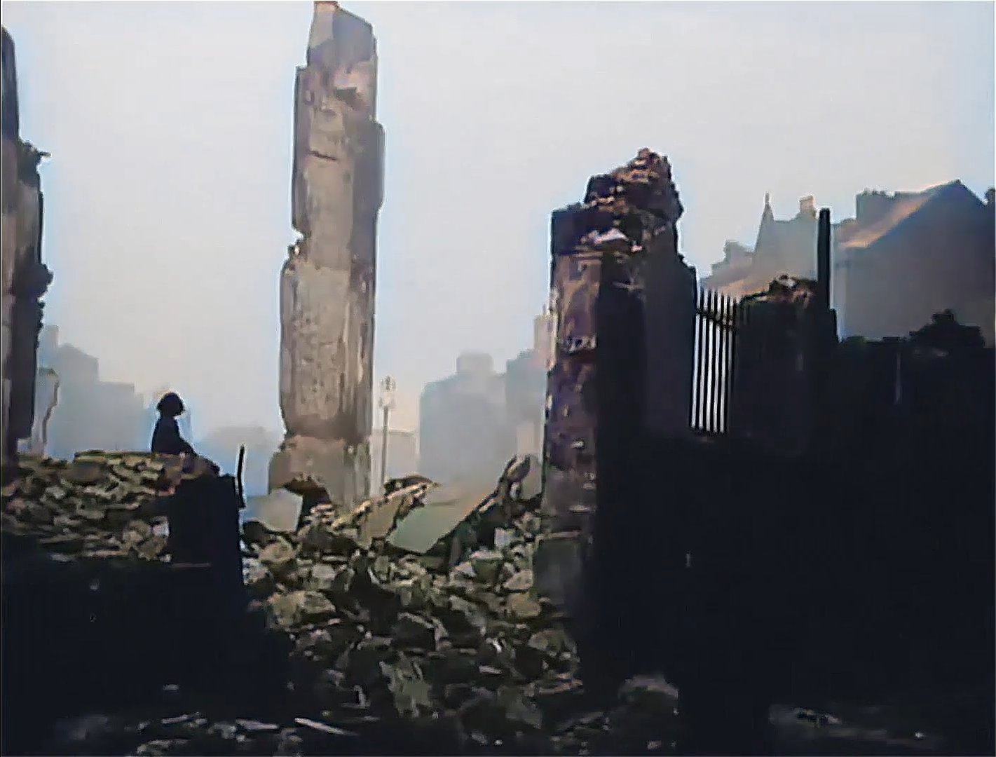 A young girl looks out over the ruins of Cork City centre